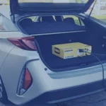 A picture of an EV vehicle with a PEMS device in the trunk