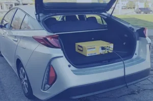 A picture of an EV vehicle with a PEMS device in the trunk