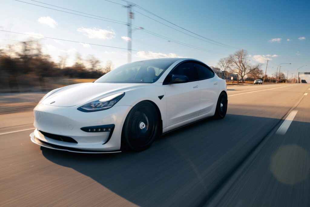 A picture of a Tesla EV vehicle on the road